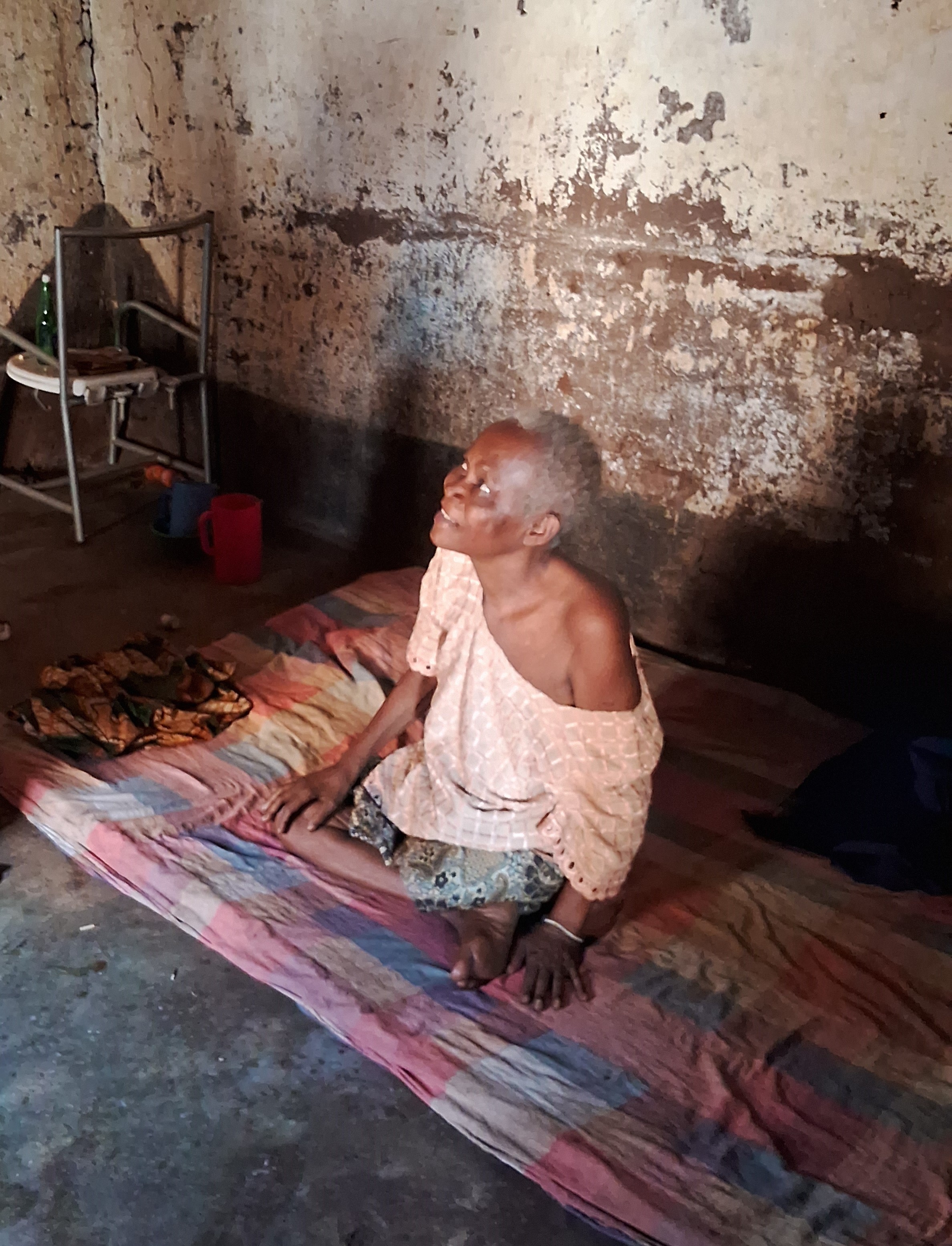 Amina smiles as she is informed of the delivery of the food parcel