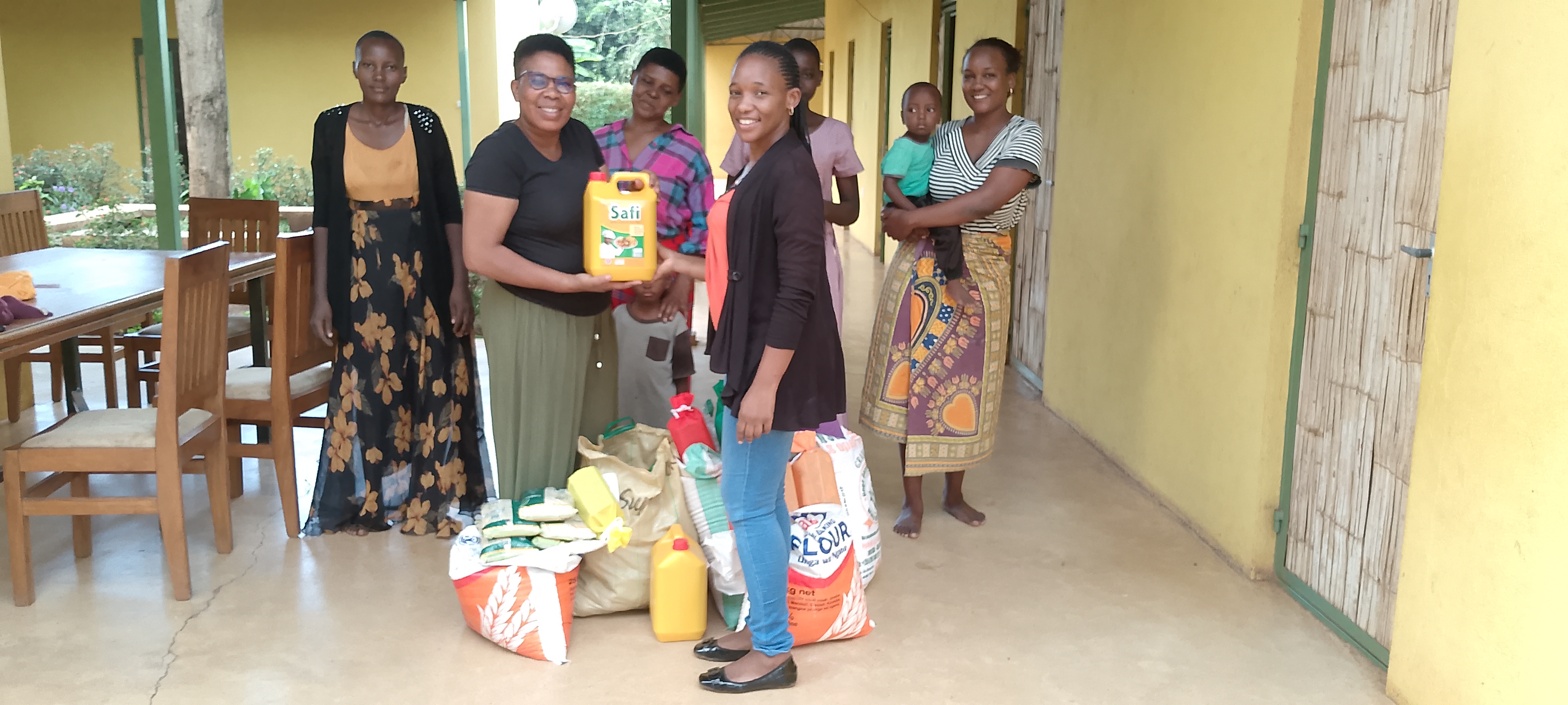 PAGE 6 PHOTO Faith Kaluse presenting emergency food supplies to the Women's Safe House in Moshi, Tanzania